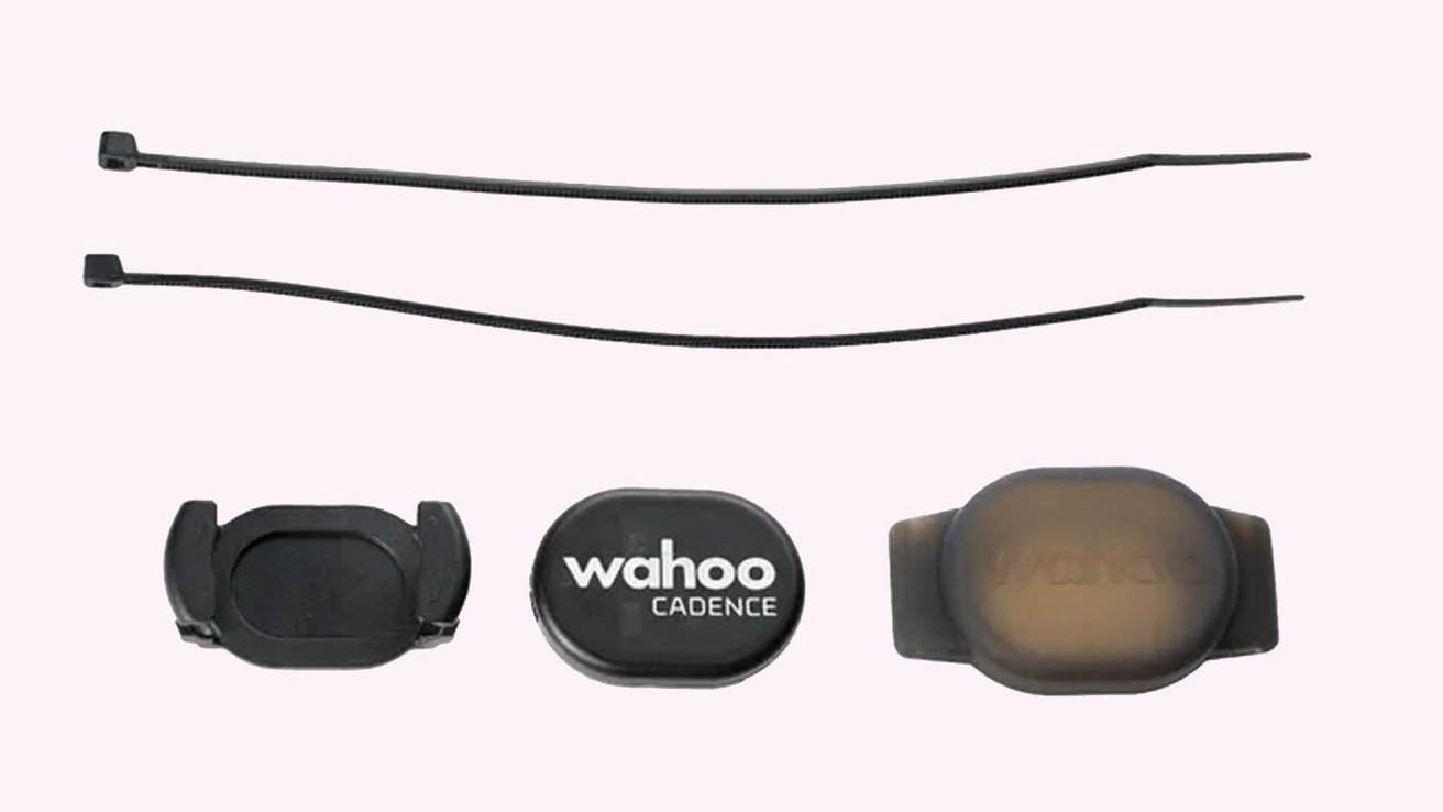 Two black zip ties above three small sensor devices labeled Wahoo Cadence arranged in a row.